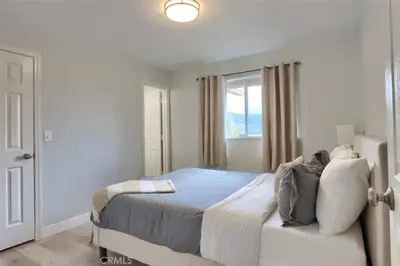a bedroom with a large bed and a window at Amazing Views Hot Tub-Games-Fire pit 6BR Sleeps 20 in Oakhurst