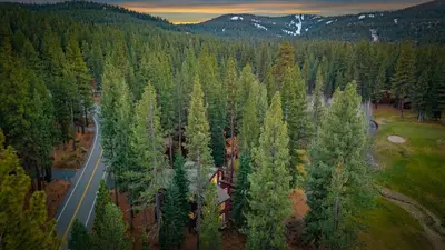 an aerial view of a road in a forest at Near Ski Resorts Downtown Truckee Donner Lake Basque Lodge by AvantStay in Truckee
