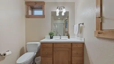 a bathroom with a sink and a toilet and a mirror at Near Ski Resorts Downtown Truckee Donner Lake Basque Lodge by AvantStay in Truckee