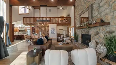 a large living room with a stone fireplace at Near Ski Resorts Downtown Truckee Donner Lake Basque Lodge by AvantStay in Truckee