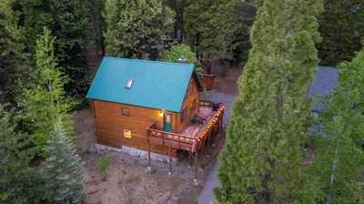 an overhead view of a cabin with a blue roof at Happy Trails-Family Style Log Home Winter Escape in Shaver Lake