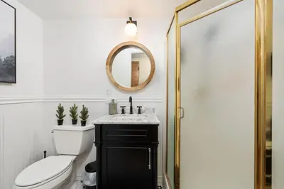 a bathroom with a toilet and a sink and a mirror at Happy Trails-Family Style Log Home Winter Escape in Shaver Lake