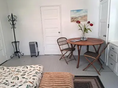 a room with a table with a vase of flowers on it at Cedar Springs Retreats in North Fork