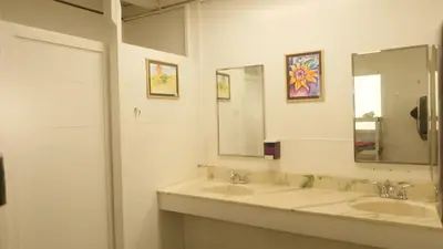 a bathroom with two sinks and a mirror at Cedar Springs Retreats in North Fork