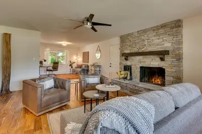 a living room with a couch and a fireplace at Marbella Lane - Eccentric 4BR Modern Ranch Home in Reno