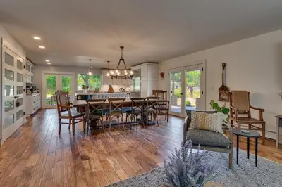 a dining room and kitchen with a table and chairs at Marbella Lane - Eccentric 4BR Modern Ranch Home in Reno