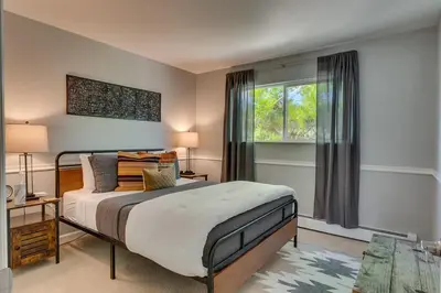 a bedroom with a bed and a window at Marbella Lane - Eccentric 4BR Modern Ranch Home in Reno