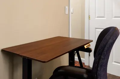 a wooden table and a chair next to a door at Luxe Cozy 1 bedroom 1 bathroom near downtown in Sacramento