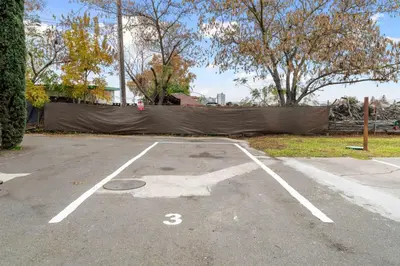 a parking lot with a fence in the background at Luxe Cozy 1 bedroom 1 bathroom near downtown in Sacramento