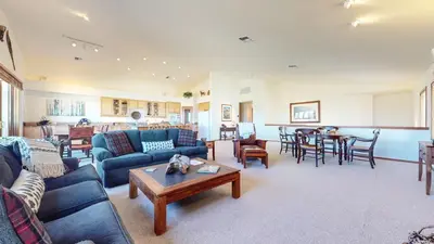 a living room with blue couches and a table at Snowcreek V #819 condo in Mammoth Lakes