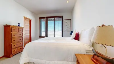 a bedroom with a white bed and a dresser and a window at Snowcreek V #819 condo in Mammoth Lakes