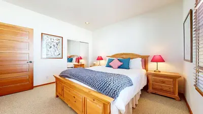 a bedroom with a bed and two lamps and a door at Snowcreek V #819 condo in Mammoth Lakes