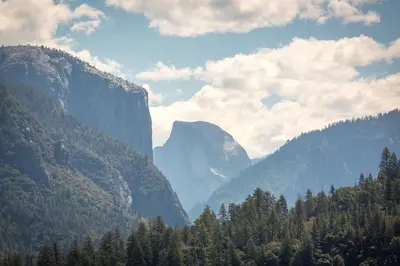 a view of a valley in the mountains with trees at Rush Creek Lodge at Yosemite in Groveland