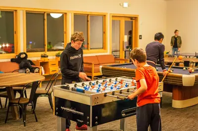 a group of young boys playing a game of chess at Rush Creek Lodge at Yosemite in Groveland