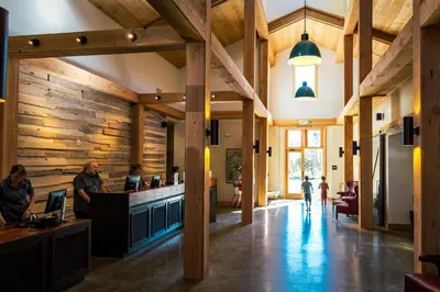 a lobby of a restaurant with people sitting at a counter at Rush Creek Lodge at Yosemite in Groveland