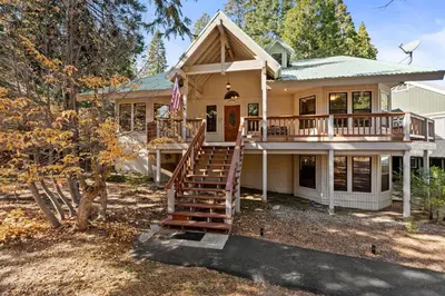 a house with a porch and a deck at Silverpine Chalet with Gym Family Friendly in Shaver Lake