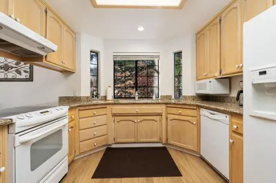 a kitchen with wooden cabinets and white appliances at Silverpine Chalet with Gym Family Friendly in Shaver Lake