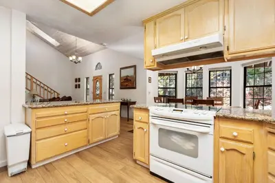 a large kitchen with wooden cabinets and white appliances at Silverpine Chalet with Gym Family Friendly in Shaver Lake