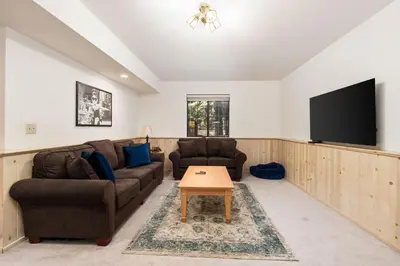 a living room with two couches and a flat screen tv at Silverpine Chalet with Gym Family Friendly in Shaver Lake