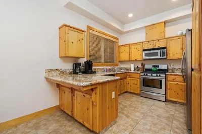 a kitchen with wooden cabinets and a counter top at Sierra Pines- Family friendly Game Room & Fire Pit in Shaver Lake