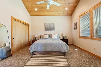 a bedroom with a bed and a ceiling fan at Sierra Pines- Family friendly Game Room & Fire Pit in Shaver Lake