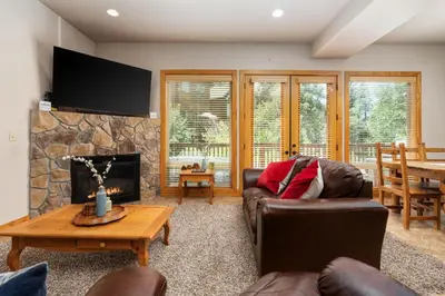 a living room with a couch and a fireplace at Sierra Pines- Family friendly Game Room & Fire Pit in Shaver Lake