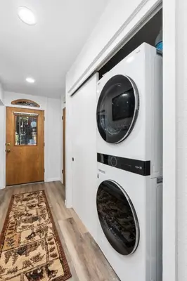 a laundry room with a washer and dryer in a wall at Wilderness Hideaway-Across from the pool & spa in Shaver Lake
