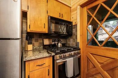 a kitchen with a stove and a microwave at Blue Meadow-Family Pet Friendly & near the lake in Shaver Lake