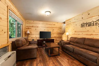 a living room with a couch and a television at Blue Meadow-Family Pet Friendly & near the lake in Shaver Lake