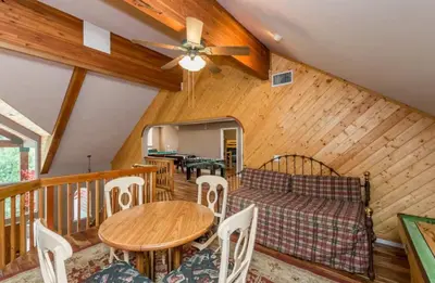 a living room with a couch and a table at Handels Pride- Family friendly Game Room & Views in Shaver Lake