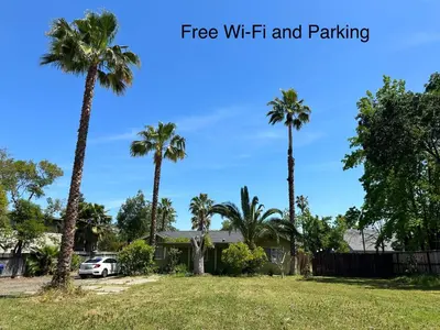 a house with palm trees in a yard at Cozy suite B in Sacramento