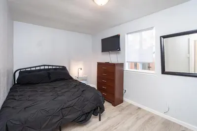 a bedroom with a bed and a dresser and a television at 2 Bedroom Home Near Downtown Zoo Golf Pet-Friendly and Fenced in Sacramento