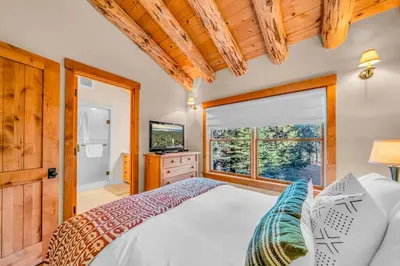 a bedroom with a bed and a large window at Lake Tahoe Haven Private Hot Tub Deck in Tahoma