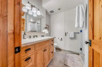 a bathroom with a sink and a toilet and a mirror at Lake Tahoe Haven Private Hot Tub Deck in Tahoma