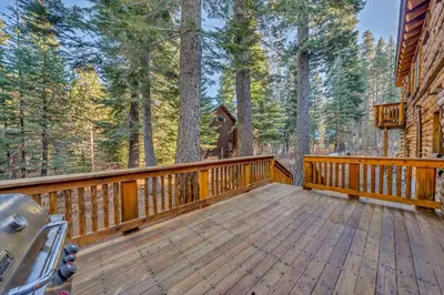 a wooden deck on a cabin in the woods at Lake Tahoe Haven Private Hot Tub Deck in Tahoma