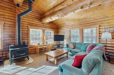 a living room with a couch and a stove at Adventure Ridge Cabin in Truckee
