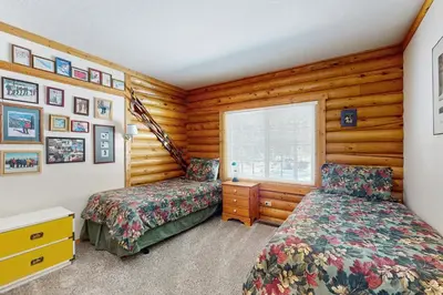 a bedroom with two beds and a window at Adventure Ridge Cabin in Truckee