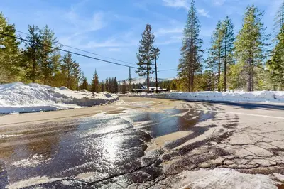 a cracked road with snow on the side of it at Adventure Ridge Cabin in Truckee