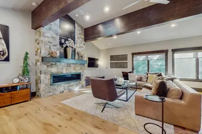 a living room with a couch and a fireplace at Lakeshore Luxe in Incline Village