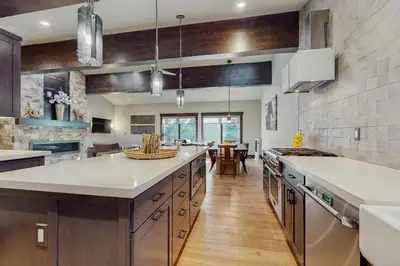 a kitchen with a large white counter top and wooden floors at Lakeshore Luxe in Incline Village
