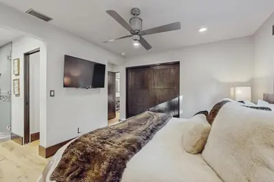 a bedroom with a couch and a ceiling fan at Lakeshore Luxe in Incline Village