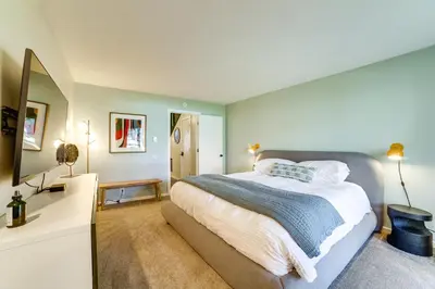 a bedroom with a large bed and a mirror at 2 Mi to Eagle Lodge! Multi-Level Haven with Hot Tub in Mammoth Lakes
