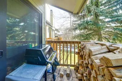 a pile of fire wood on a porch with a television at 2 Mi to Eagle Lodge! Multi-Level Haven with Hot Tub in Mammoth Lakes