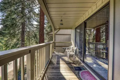 a porch of a house with a chair on it at Kingswood Pines in Kings Beach