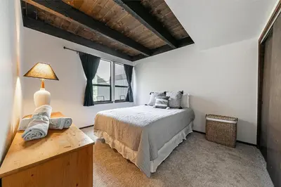 a bedroom with a bed and a large window at Kingswood Pines in Kings Beach
