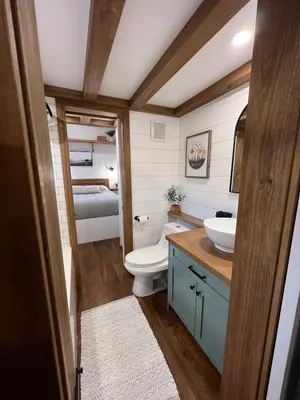 a bathroom with a toilet and a sink and a bed at Tiny Rustic at Yosemite Gateway in Groveland