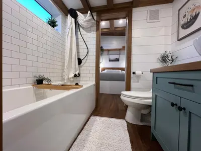 a bathroom with a tub and a toilet and a sink at Tiny Rustic at Yosemite Gateway in Groveland