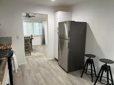 a kitchen with a stainless steel refrigerator and two stools at Yosemite Gateway home in Groveland in Groveland