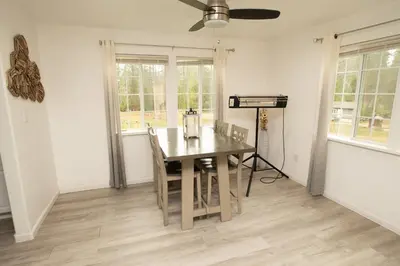a dining room with a table and chairs and windows at Yosemite Gateway home in Groveland in Groveland