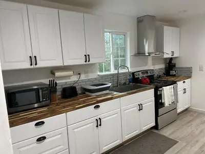 a kitchen with white cabinets and a sink and a microwave at Yosemite Gateway home in Groveland in Groveland